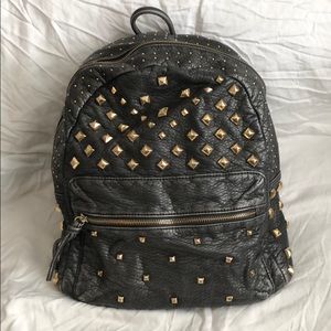 Distressed vegan leather with gold studs
